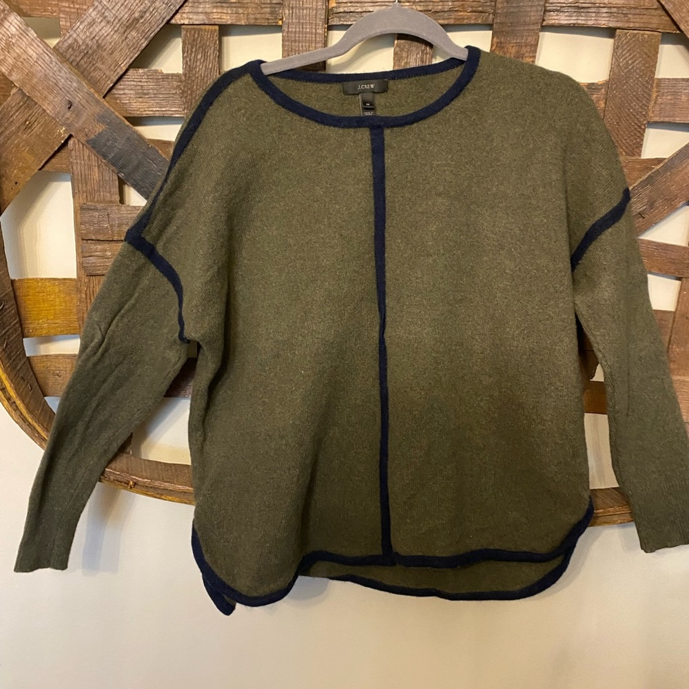 100% wool sweater. Army green with navy blue piping.